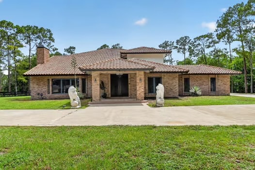 Front of home with stone lions — 14780 Draft Horse Lane